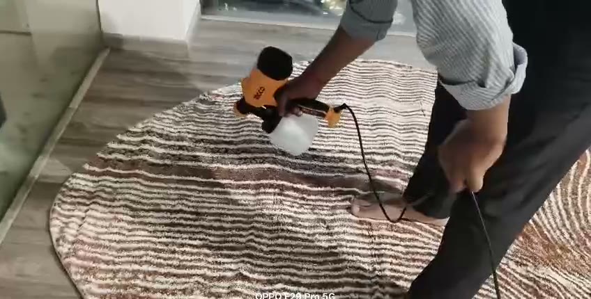 Technician coating a designer rug